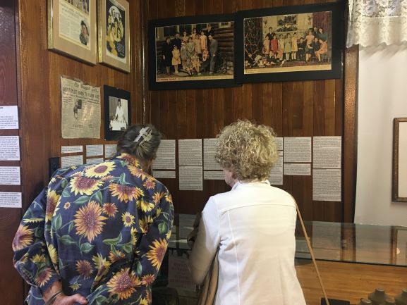 Two guests read educational panels on the Dionne quintuplets in the museum